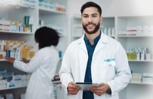 Man in pharmacy holding a tablet